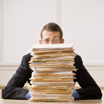 Businessman Behind Stack of File Folders